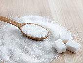 Sugar on wooden table. Selective focus