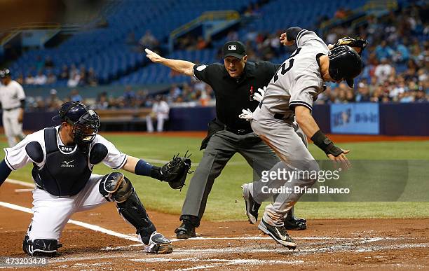 Jacoby Ellsbury of the New York Yankees scores in front of catcher Bobby Wilson of the Tampa Bay Rays off of a single by Mark Teixeira as home plate...