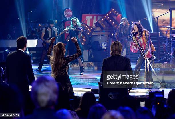 Musician Steven Tyler performs onstage with American Idol judges Harry Connick Jr., Jennifer Lopez, and Keith Urban during "American Idol" XIV Grand...