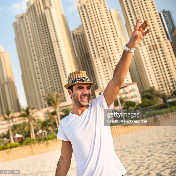 man dancing on a beach party in dubai marina beach - emirati dance stock pictures, royalty-free photos & images