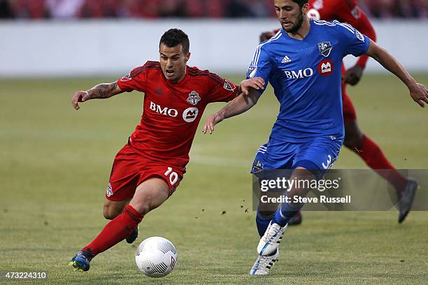 Toronto FC midfielder Sebastian Giovinco tries to get past Montreal Impact defender Eric Miller as Toronto FC beats the Montreal Impact 3-2 in the...