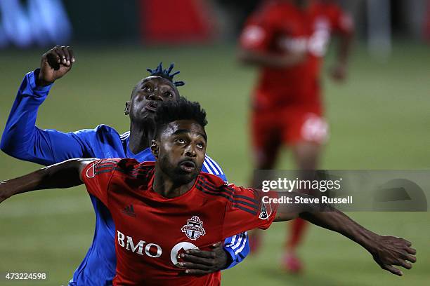 Toronto FC defender Warren Creavalle and Montreal Impact forward Dominic Oduro battle for the ball as Toronto FC beats the Montreal Impact 3-2 in the...