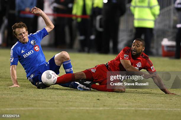 Toronto FC defender Ashtone Morgan is taken down by Montreal Impact defender Wandrille Lefevre as Toronto FC beats the Montreal Impact 3-2 in the...