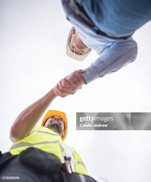 construction workers handshaking - handshake site stock pictures, royalty-free photos & images