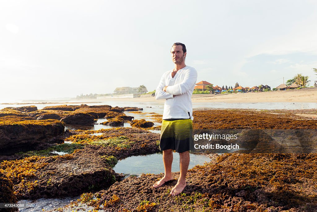 Attractive Man Enjoys View at Scenic Bali Beach Travel Destination