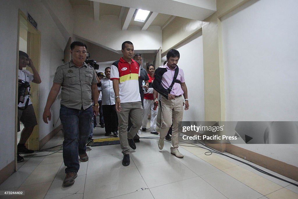 Filipino boxing champion Manny Pacquiao (R) walks to the...