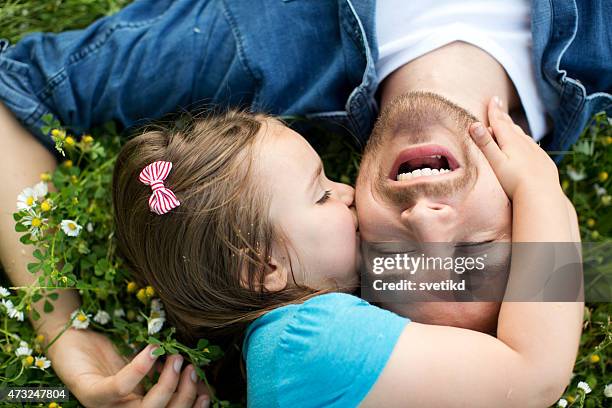father and daughter outdoors in a meadow. - fathers day stock pictures, royalty-free photos & images