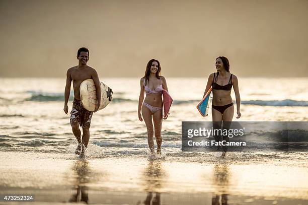 friends on the beach - board shorts stock pictures, royalty-free photos & images