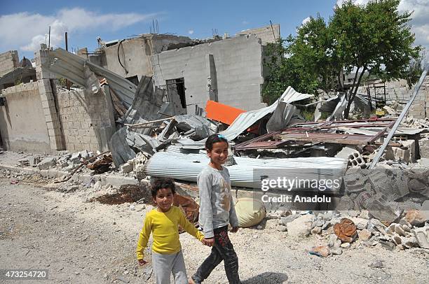 Kids are seen among the rubble of buildings destroyed in the clashes between DAESH militants and Kurdish armed groups are seen in the center of the...