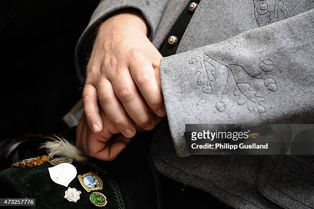 Pilgrim in traditional Bavarian folk dress folds his hands for prayer during the annual Ascension Mass at the open-air altar at Birkenstein on May...