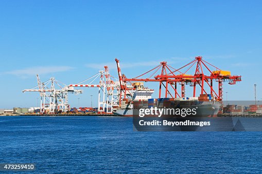Cargo container ship loading/unloading in port Cargo container ship loading/unloading in port