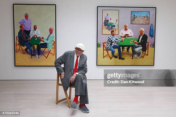 British artist David Hockney sits in front of two works entitled 'Card Player and Bigger Card Players' during the launch of his new exhibition...