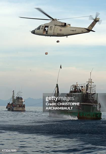 Thai army helicopter drops food supplies near a boat carrying Rohingya migrants and drifting in Thai waters off the southern island of Koh Lipe in...