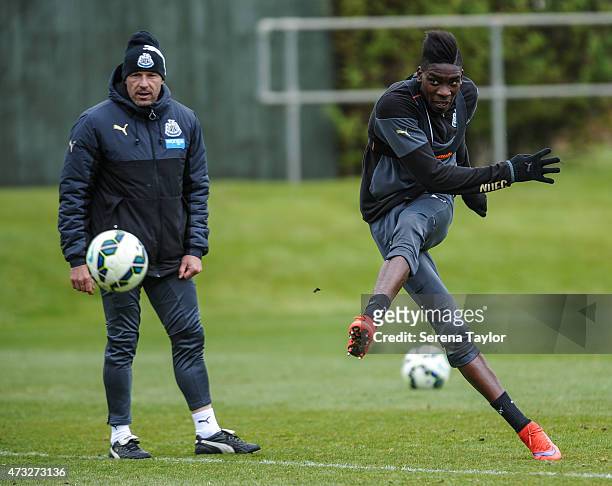 Sammy Ameobi strikes the ball whilst First Team Coach Steve Stone looks on during a Newcastle United Training session at The Newcastle United...