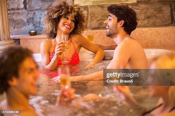 group of young people relaxing in a hot tub and communicating. - hot tub party stock pictures, royalty-free photos & images