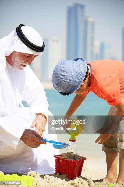 grandfather and grandson enjoying their leisure time - saudi grandfather stock pictures, royalty-free photos & images