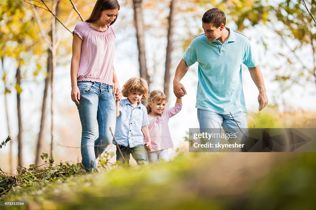 Young family enjoying while walking in nature.