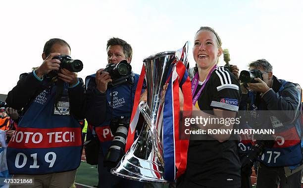 Frankfurt's defender Marith Priessen holds the trophy as she celebrates with after their 2-1 win in the UEFA Champions League women football match...