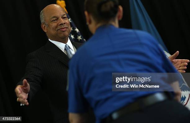 Homeland Security Secretary Jeh Johnson hugs TSA security officer Carol Richel before presenting her the DHS Secretary's Award for Valor May 14, 2015...