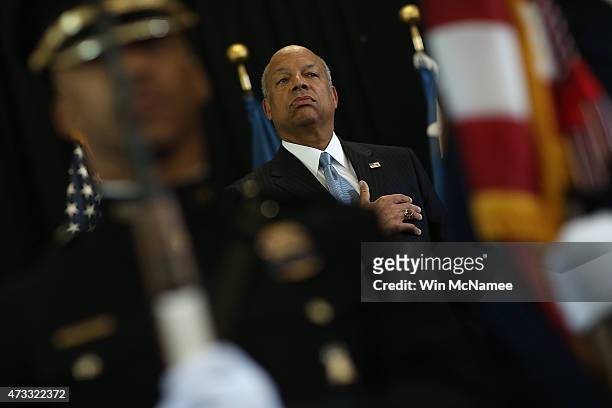 Homeland Security Secretary Jeh Johnson places his hand over his heart during the playing of the U.S. National anthem before presenting the DHS...