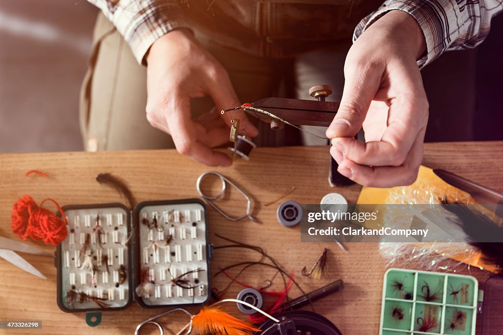 Overhead View Of a Fly Fisherman Tying Flies For Fishing