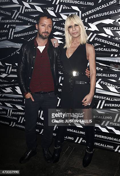 Italian designer Donatella Versace and Versuss creative director Anthony Vaccarello arrive for the launch party of Versace's diffusion label at the...