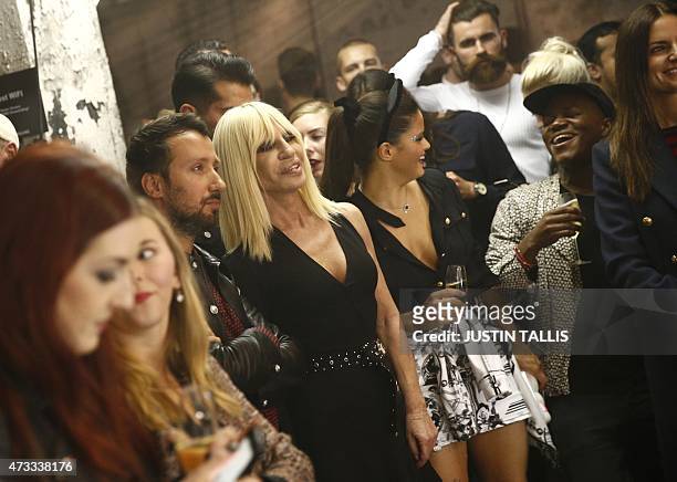 Italian desinger Donatella Versace and Versuss creative director Anthony Vaccarello take part in the launch party of Versace's diffusion label at the...