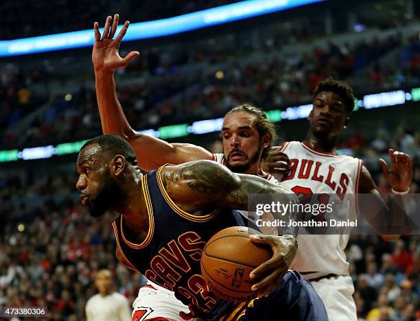LeBron James of the Cleveland Cavaliers drives against Jimmy Butler and Joakim Noah of the Chicago Bulls in the first quarter during Game Six of the...