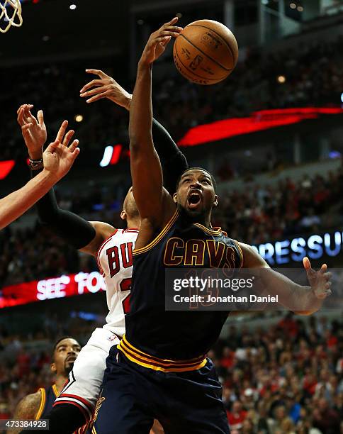 Tristan Thompson of the Cleveland Cavaliers pulls down a rebound against Taj Gibson of the Chicago Bulls in the fourth quarter during Game Six of the...