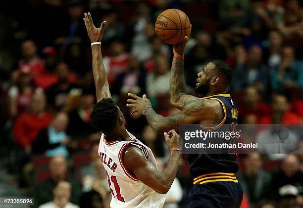 LeBron James of the Cleveland Cavaliers shoots against Jimmy Butler of the Chicago Bulls in the fourth quarter during Game Six of the Eastern...