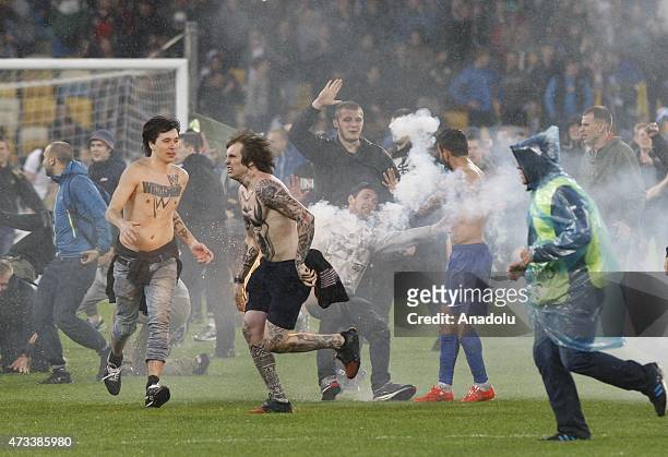 Some fanatics stage violent behaviors as the fans and Dnipro players celebrate their victory after the UEFA Europa League Semi Final second leg match...