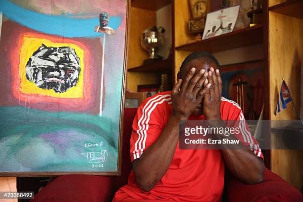 Picture of Flix Savn with his paintings titled "The Last Fight" at his home on May 10, 2015 in Havana, Cuba. After Savn retired from boxing, he...