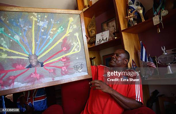 Picture of Flix Savn with his paintings titled "Expecting the 21st Century" at his home on May 10, 2015 in Havana, Cuba. After Savn retired from...