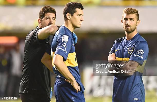 Agustin Orion , Gino Peruzzi and Guillermo Burdisso of Boca Juniors await while a second leg match between Boca Juniors and River Plate is delayed...