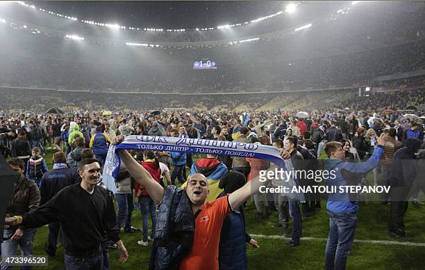 Dnipro's supporters celebrate at the end of the UEFA Europa League semi-final second leg football match between FC Dnipro and SSC Napoli in Kiev on...