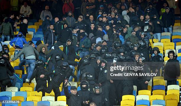 Police officers gather around SSC Napoli's supporters in the stands after the UEFA Europa League semi-final second leg football match between FC...