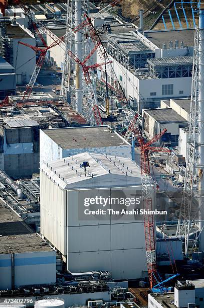 In this aerial image, preparatory work to remove the cover around the No. 1 reactor building starts at Tokyo Electric Power Co's Fukushima Daiichi...