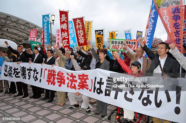 Pro peace constitution protesters demonstrate at Nagasaki Station on May 14, 2015 in Nagasaki, Japan. Abe cabinet approved 11 bills that will expand...