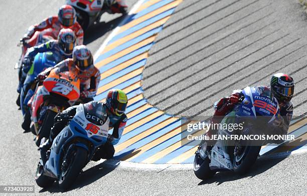 Spain's rider Jorge Lorenzo on his Movistar Yamaha N°99 competes ahead of San Marino's rider Alex de Angelis on his Art Octo Ioda Racing Team N°15...