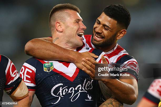 Shaun Kenny-Dowall of the Roosters shares a laugh with his team mate Daniel Tupou of the Roosters as they wait for the video referee decision during...