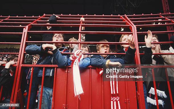 Young Manchester United fans look on through the fence during a First Division match at Old Trafford circa september 1980, in Manchester, England.