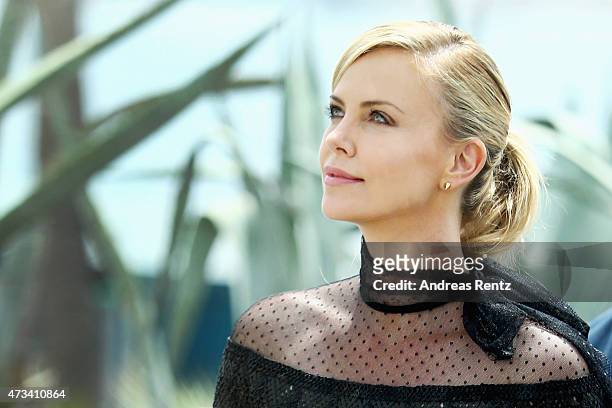 Charlize Theron looks up after she leaves a photocall for "Mad Max: Fury Road" during the 68th annual Cannes Film Festival on May 14, 2015 in Cannes,...