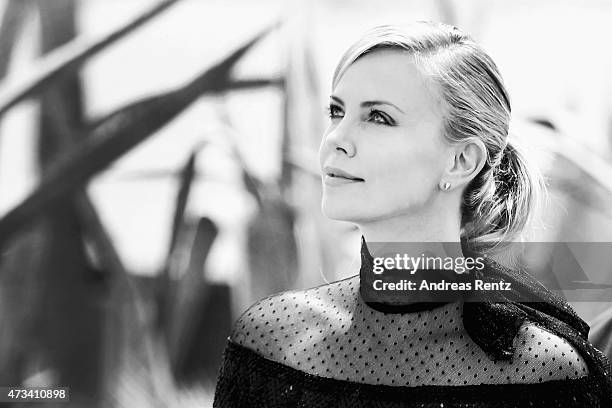 Charlize Theron looks up after she leaves a photocall for "Mad Max: Fury Road" during the 68th annual Cannes Film Festival on May 14, 2015 in Cannes,...