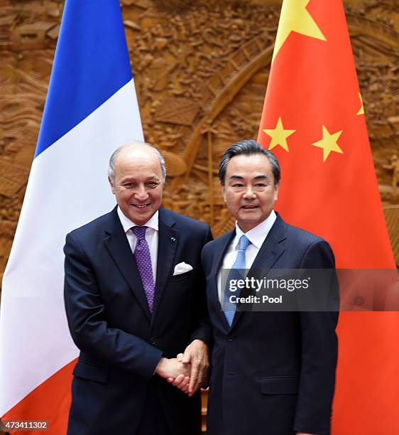 Chinese Foreign Minister Wang Yi shakes hands with his French counterpart Laurent Fabius during a meeting on May 15, 2015 in Beijing, China. Fabius...