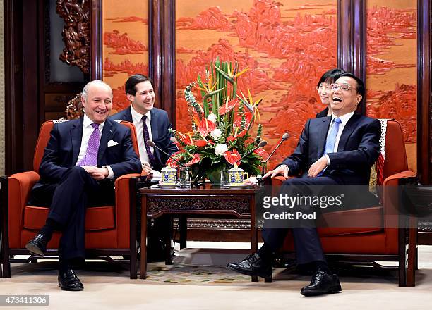 Chinese Premier Li Keqiang shares a light moment with French Foreign Minister Laurent Fabius during a meeting at the Zhongnanhai leadership compound...