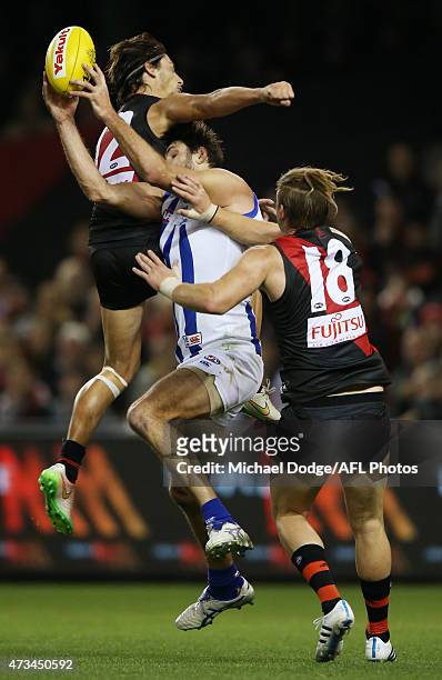 Mark Baguley of the Bombers collides with Jarrad Waite of the Kangaroos and gives away a free kick during the round seven AFL match between the...