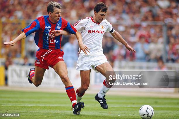 Crystal Palace player Alan Pardew challenges Bryan Robson during the 1990 FA Cup final between Crystal Palace and Manchester United at Wembley...