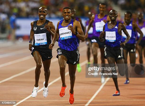 Hagos Gebrhiwet of of Ethiopa finishes ahead of Mo Farah of Great Britain to win the Men's 3000m during the Doha IAAF Diamond League 2015 meeting at...