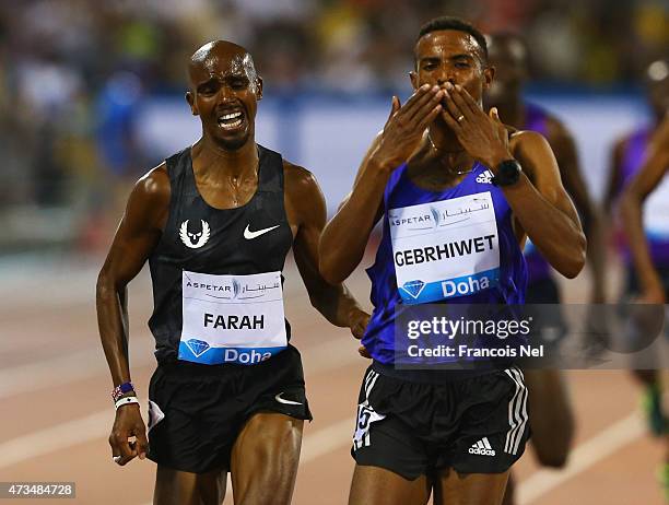 Hagos Gebrhiwet of of Ethiopa finishes ahead of Mo Farah of Great Britain to win the Men's 3000m during the Doha IAAF Diamond League 2015 meeting at...