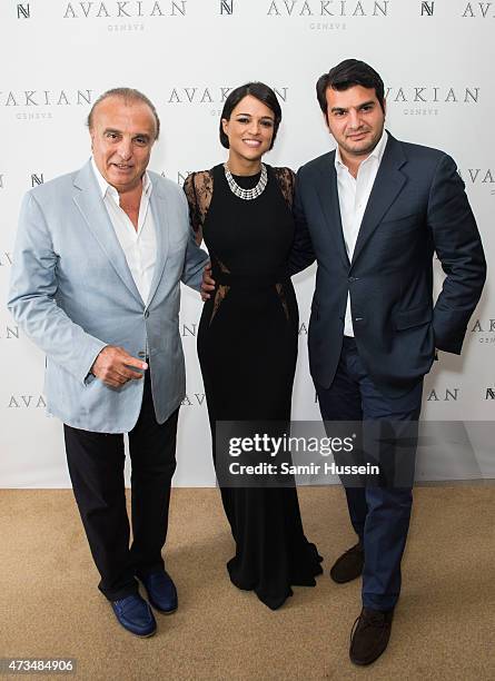 Michelle Rodriguez poses with Haig Avakian and Edmond Avakian as she visits The Avakian Suite during The 68th Annual Cannes Film Festival at The...